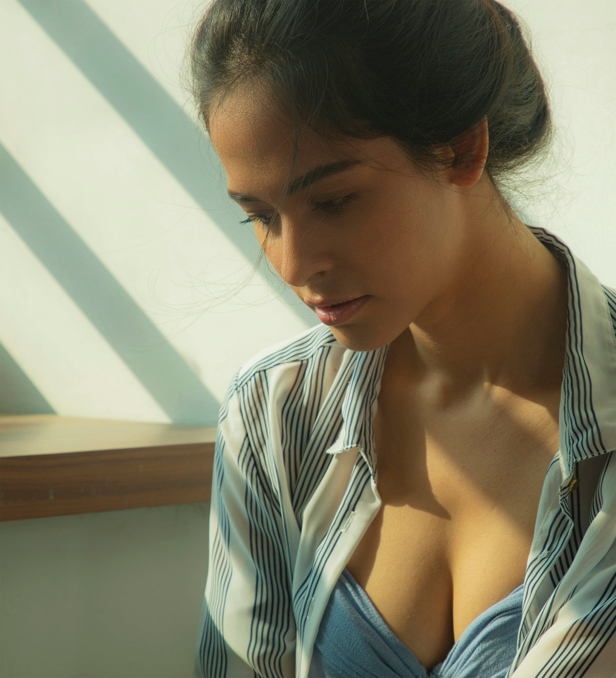 woman in white and blue striped shirt