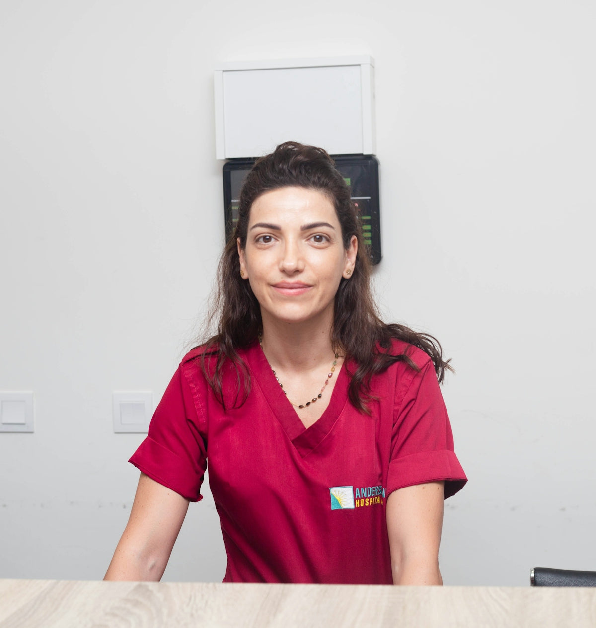 A smiling medical professional is posed